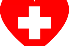 Ett rött hjärta med vit text det står First Aid på.